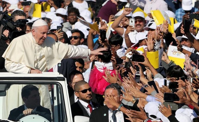 Pope Francis is greeted by as he arrives to hold a mass at Zayed Sports City Stadium in Abu Dhabi